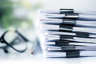 © Adobe Images:extreamly close up the stacking of office working document with paper clip folder